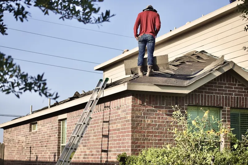 Professional roofer working on a residential roof in East Hampton